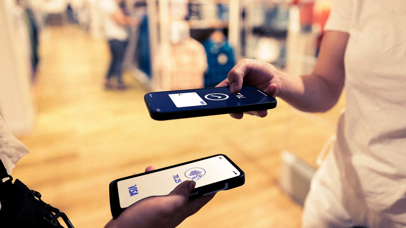 People paying each other using smartphones with apps showing Visa branding.