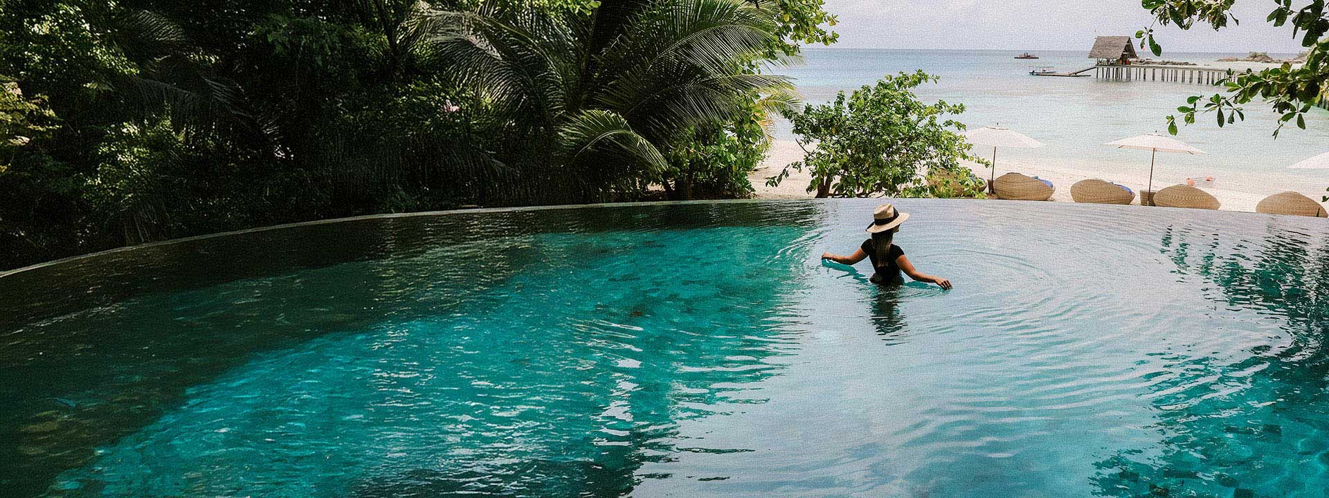 Person in the pool overlooking the ocean
