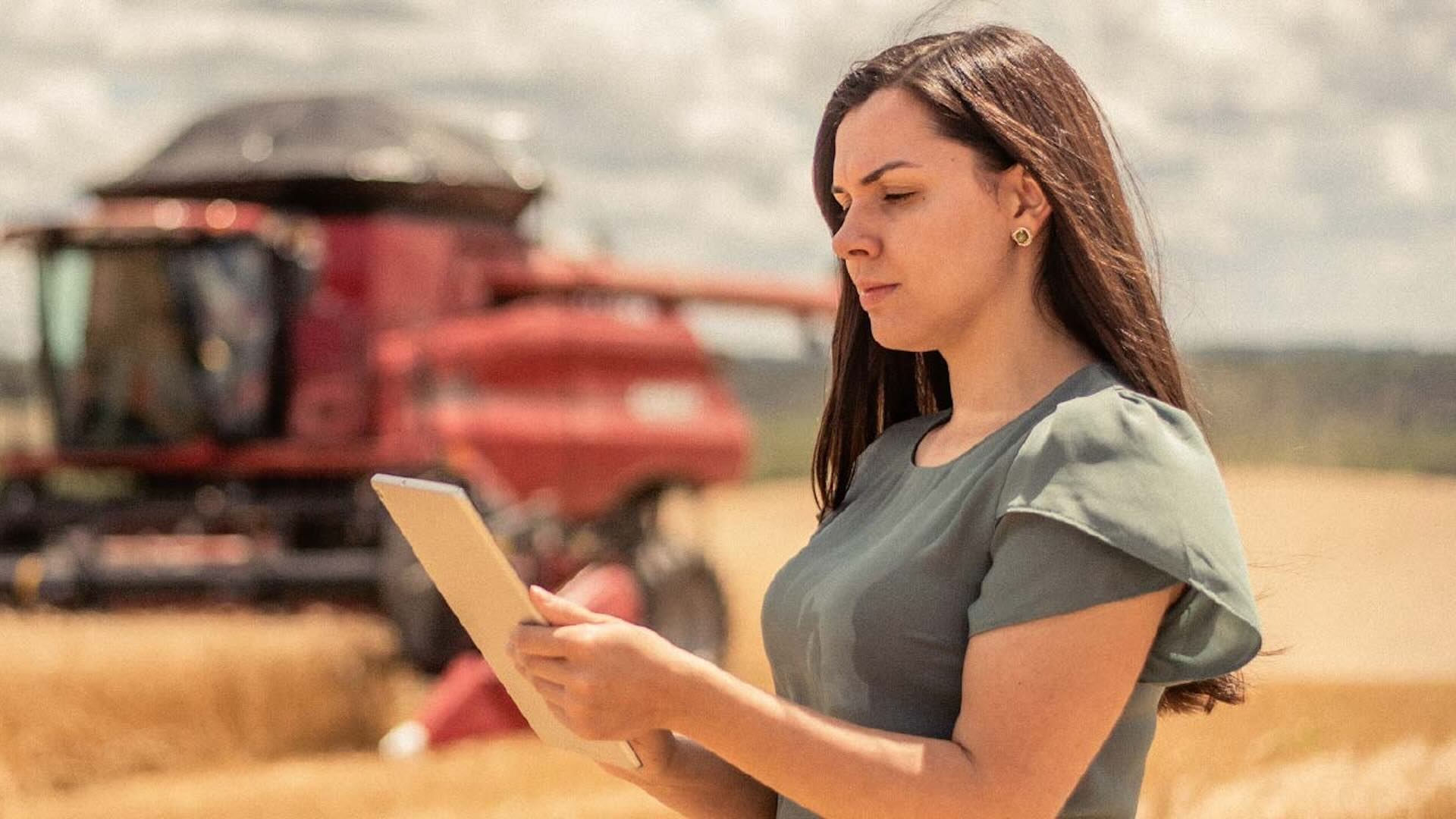 woman looking at ipad on farmland